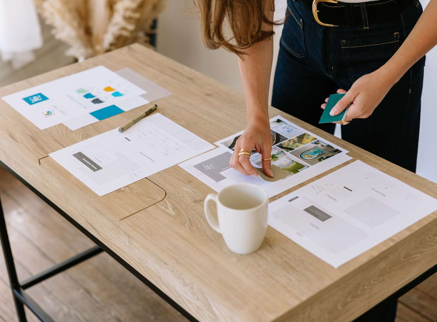 Woman preparing mood board on desk for Current Design Co.